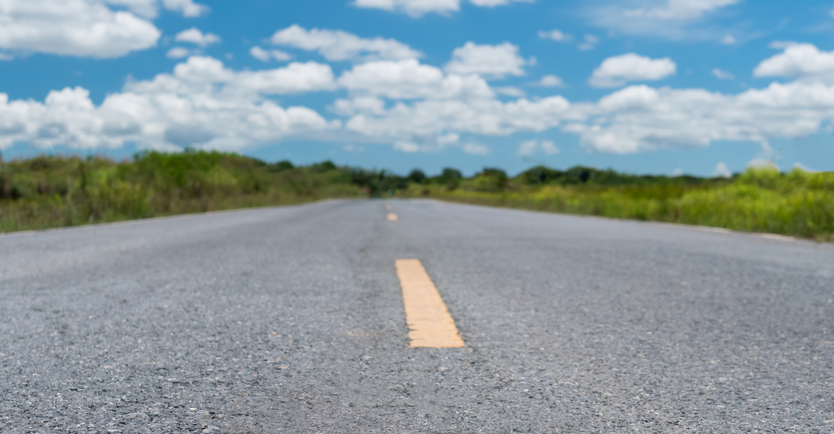 Small country road or street with blue sky background.