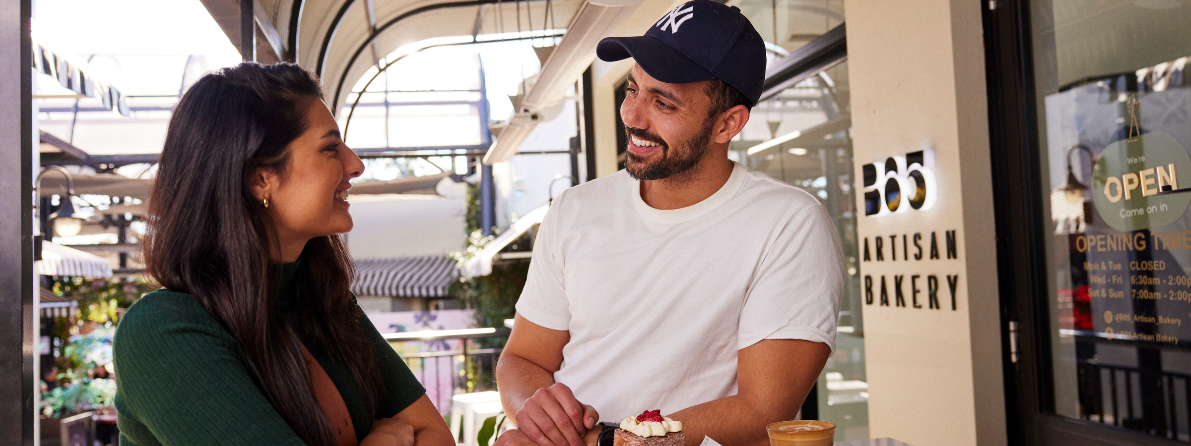 Couple enjoying a coffee and baked treat at B85 Artisan Bakery in Camden.