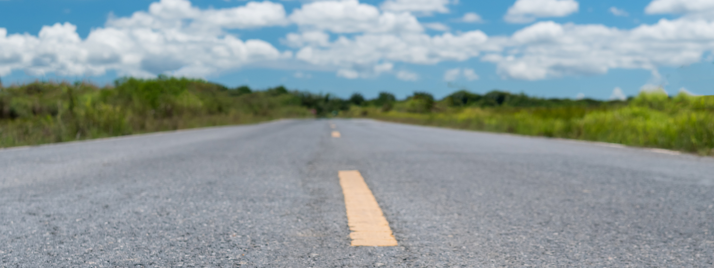 Small country road or street with blue sky background.