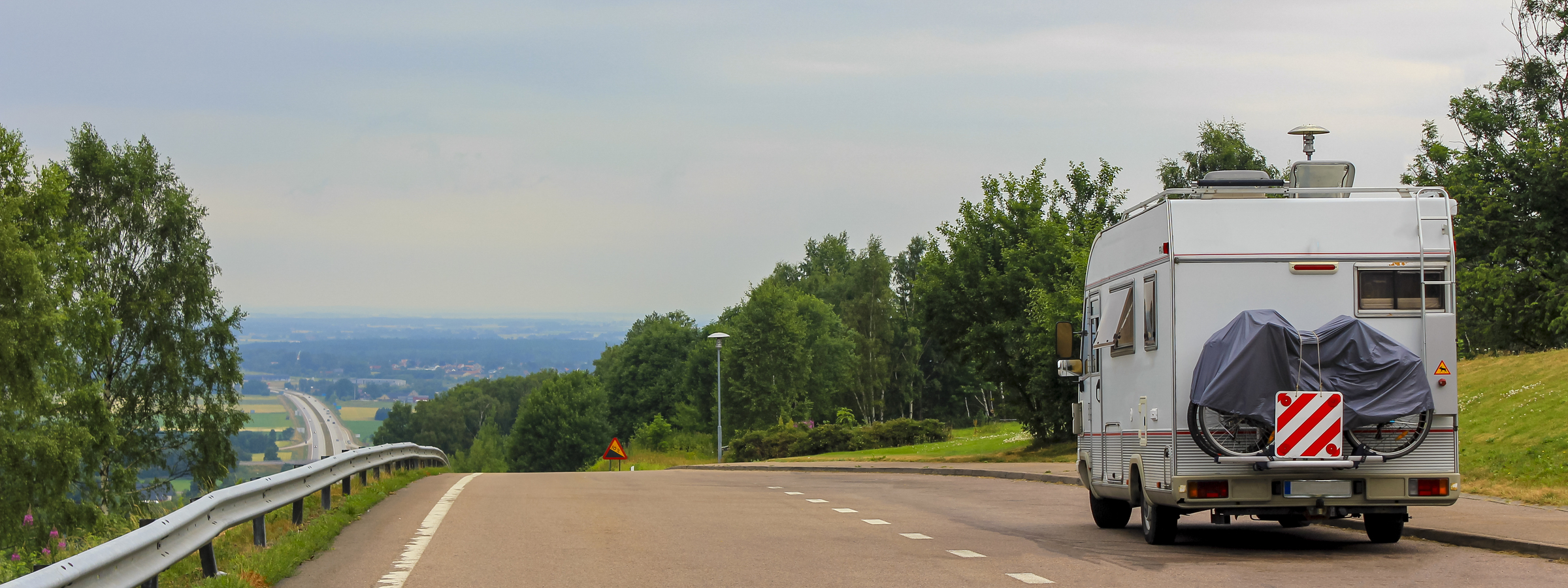 Caravan camper on the road from the rest area to the motorway somewhere in Sweden.