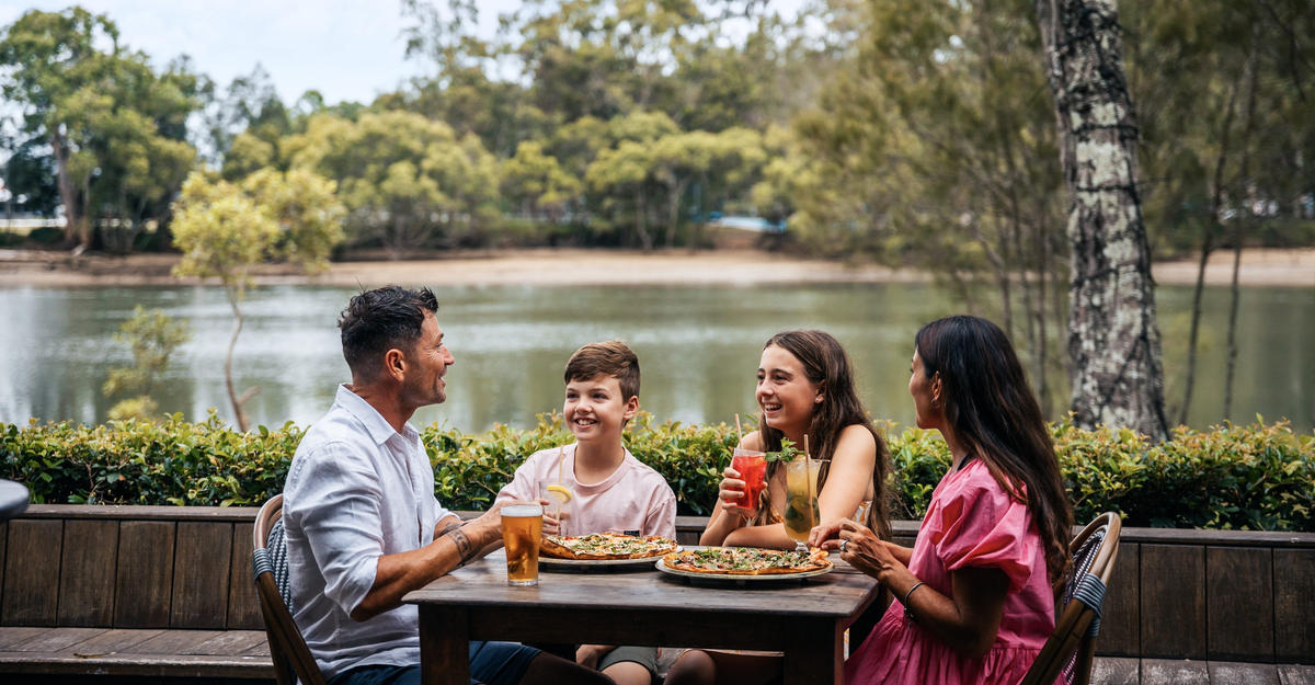 Family having pizza and drinks at the waterfront restaurant