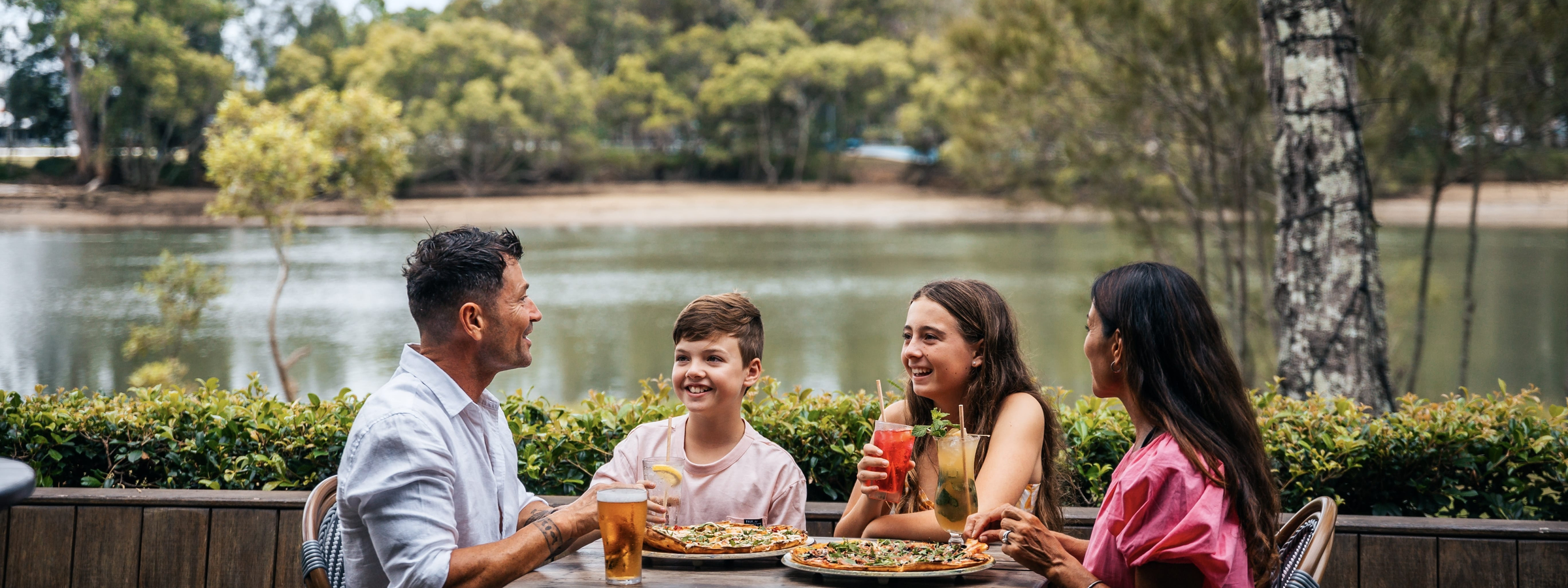 Family having pizza and drinks at the waterfront restaurant