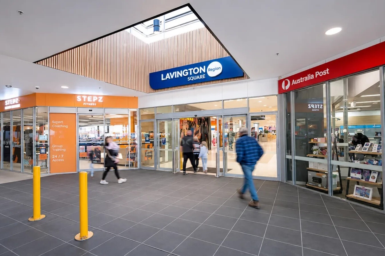 Shoppers entering Lavington Square near Australia Post and Stepz Fitness.