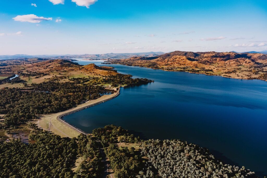 Aerial view of Lake Hume surrounded by rolling hills and bushland.