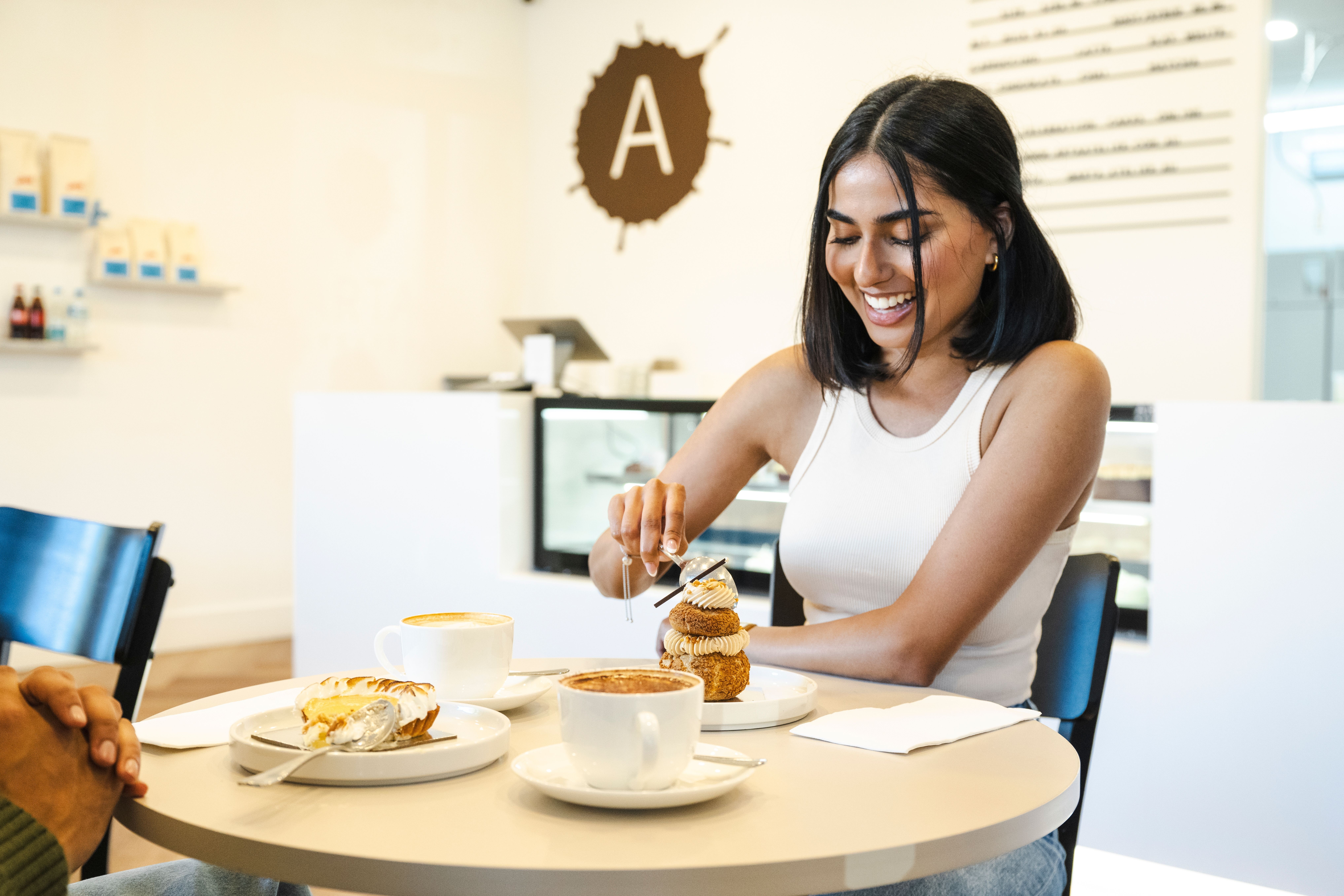 Couple enjoys a sweet treat and coffee at patisserie Arta Atelier in Camden