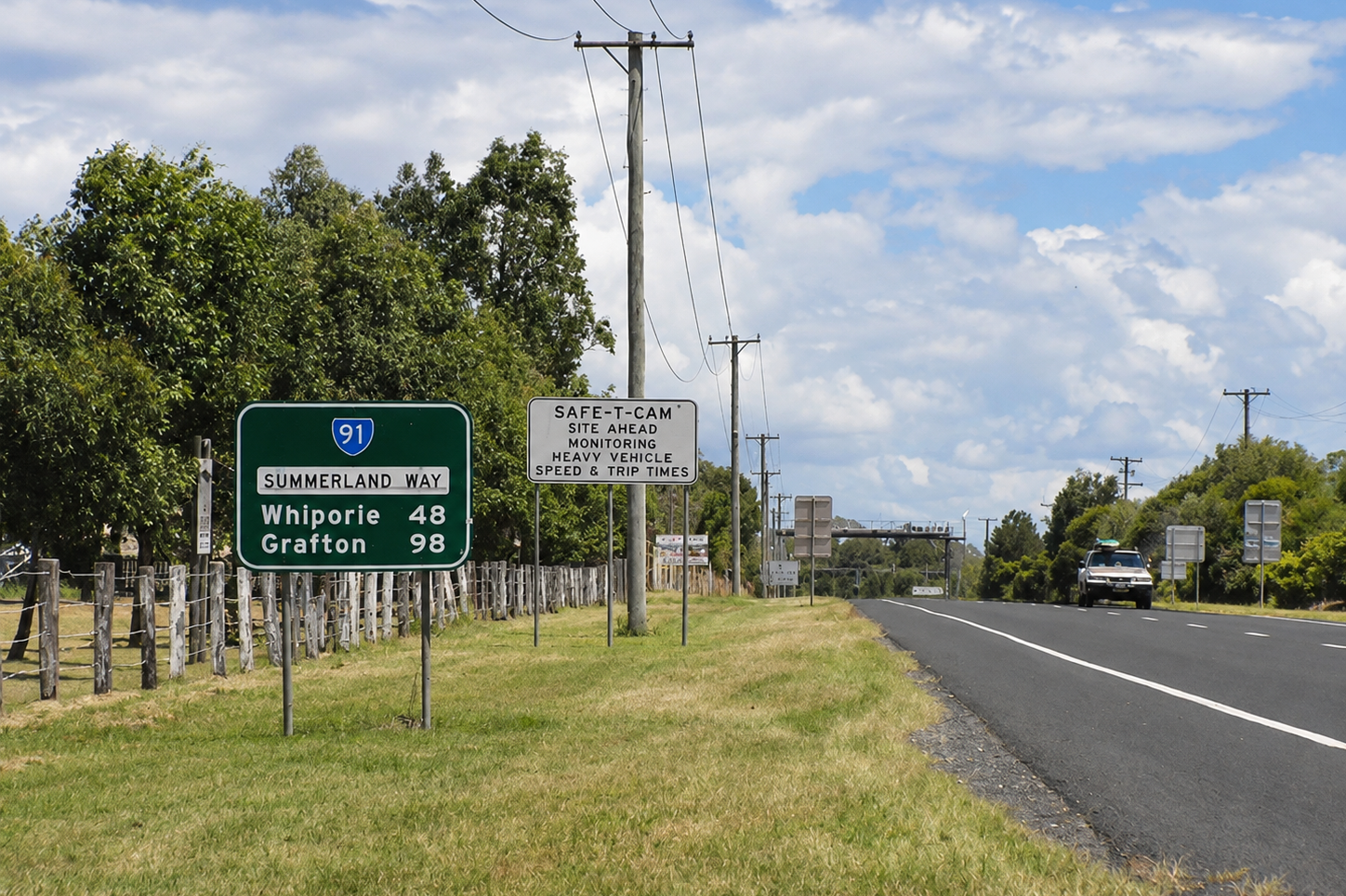 Summerland Way road sign showing distances to Whiporie and Grafton.