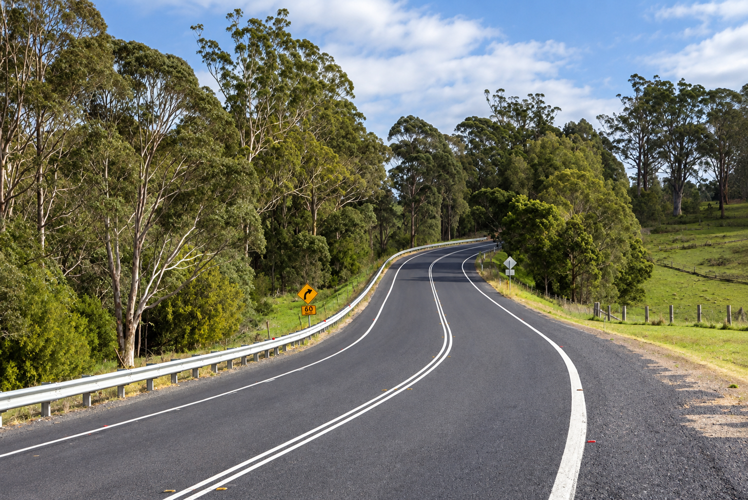 Princes Highway winding through forest and rural countryside.