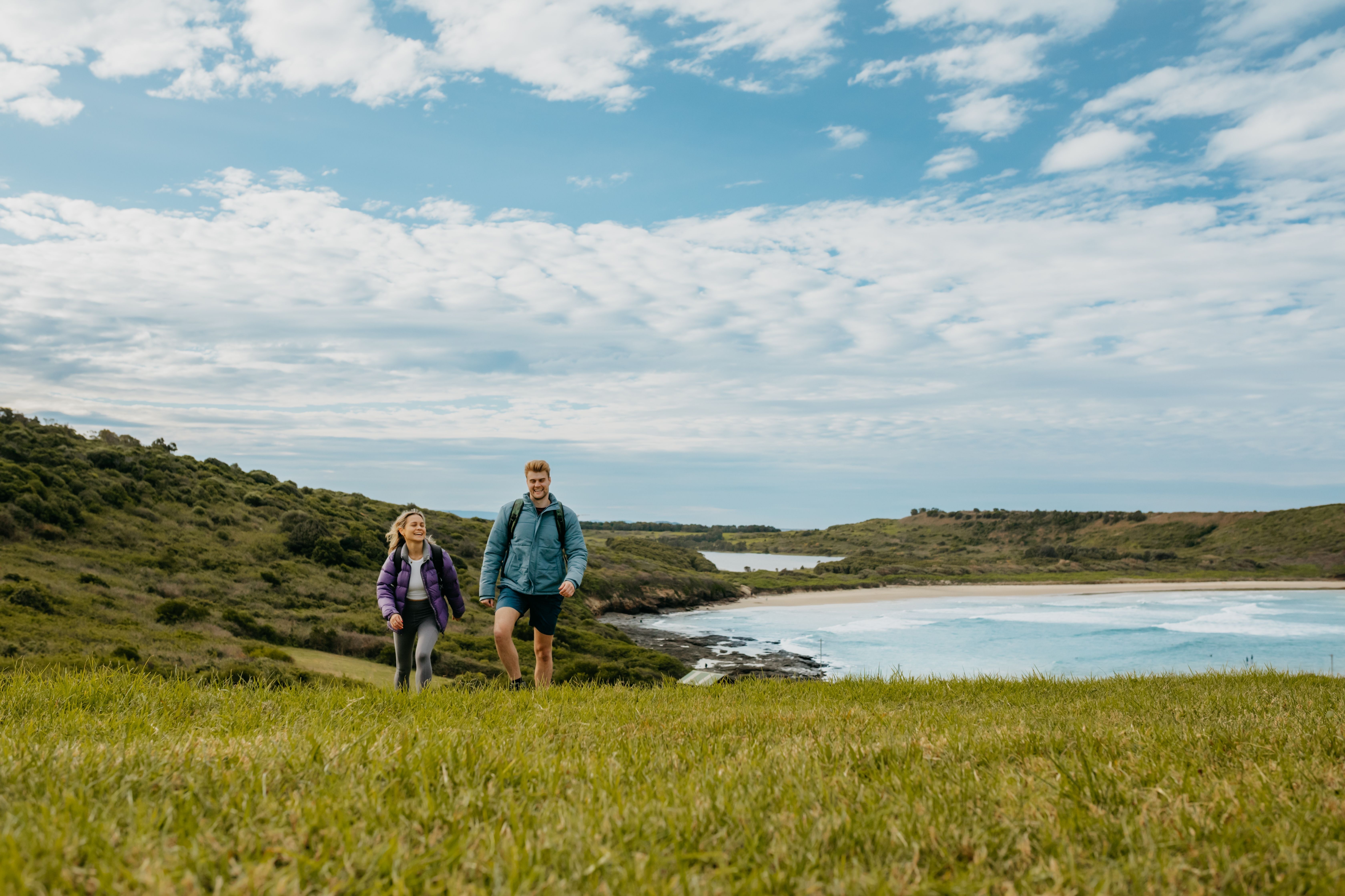 Couple enjoys a walk at Killalea Beach, Shellharbour
