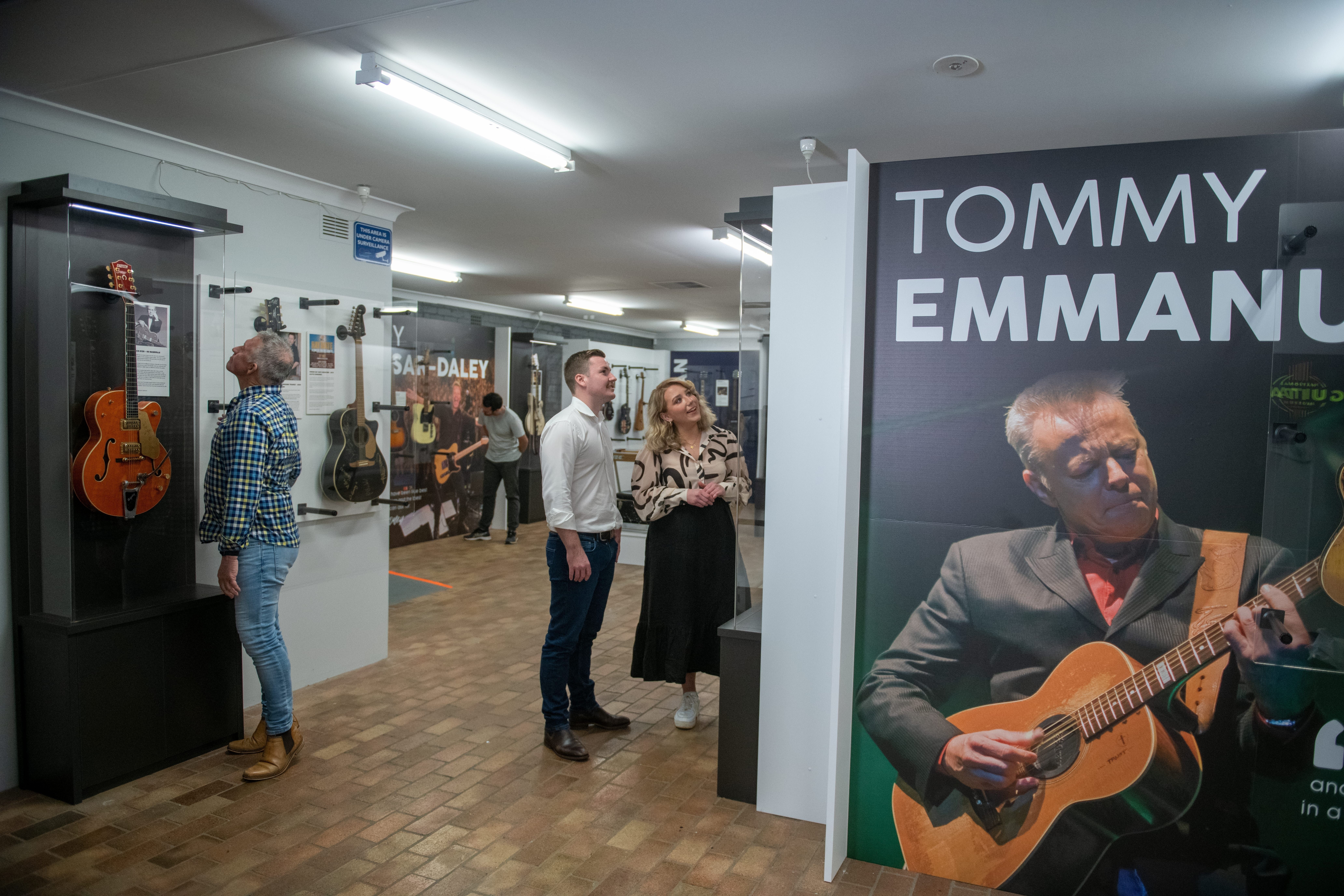The Big Golden Guitar Tourism Centre based in Tamworth. Tamworth is the Country Music Capital of NSW and home to the Tamworth Country Music Festival. People inside the Big Golden Guitar Tourist Centre viewing the museum pieces of country music memorabilia.