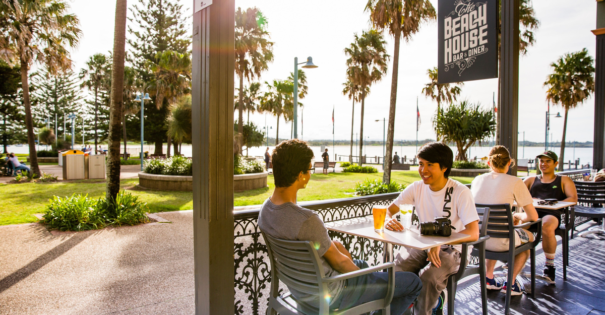 Friends enjoying afternoon drinks at The Beach House Restaurant and Bar, Port Macquarie.