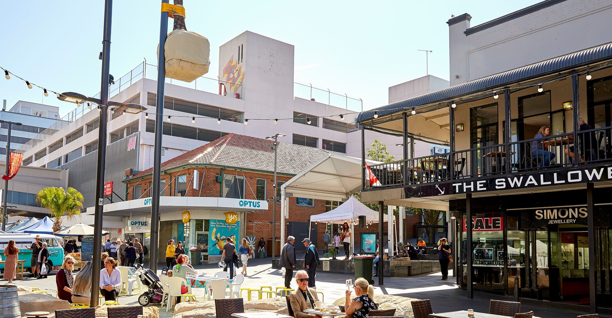 People enjoying the outdoor seating and cafes in the town centre of Wollongong.