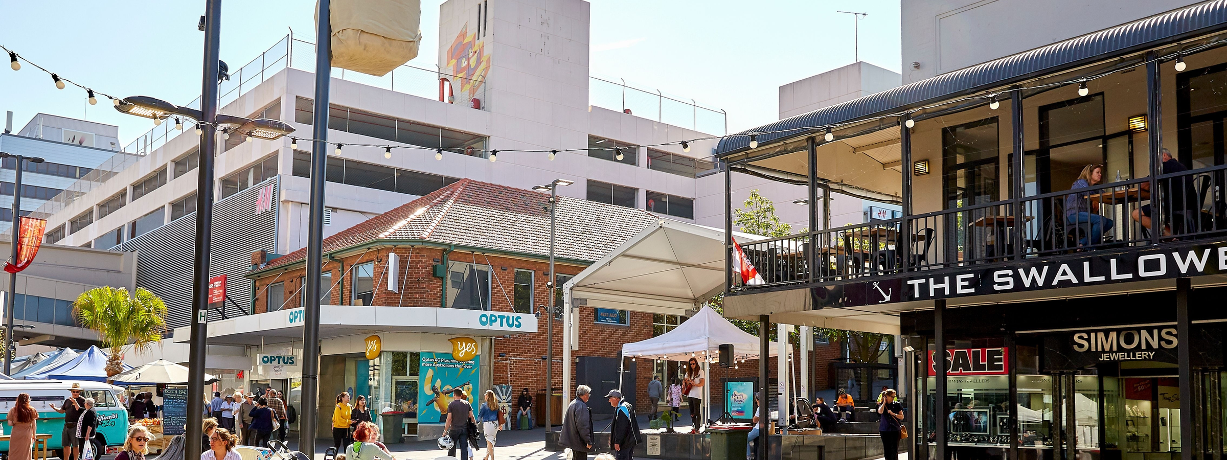 People enjoying the outdoor seating and cafes in the town centre of Wollongong.
